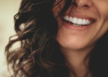 long black haired woman smiling close-up photography