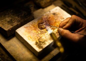 person holding silver safety pin